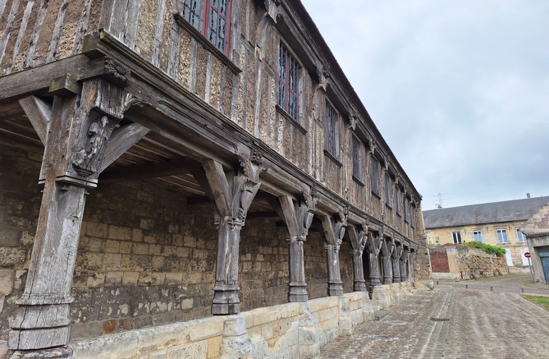 A medieval half-timbered building with its upper storey supported on wooden columns.