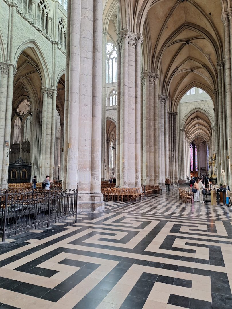 Inside the cathedral. Soaring columns and a black-and-white geometrically-patterned floor