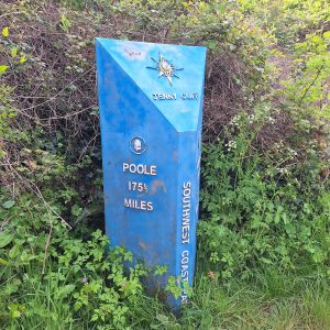 A blue SWCP milepost "Jenny Cliff" and "Poole 175 1/2 miles"